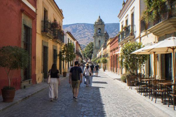 Small group on a guided walk past a colonial church in Oaxaca