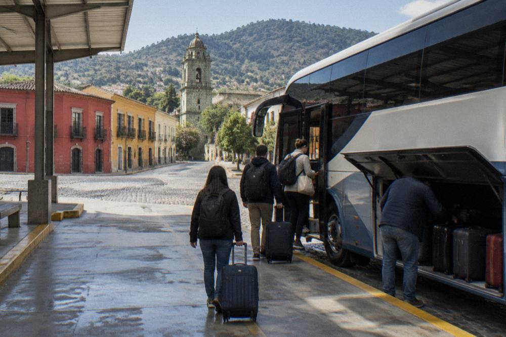Passengers with luggage boarding a long-distance coach at an Mexican bus terminal