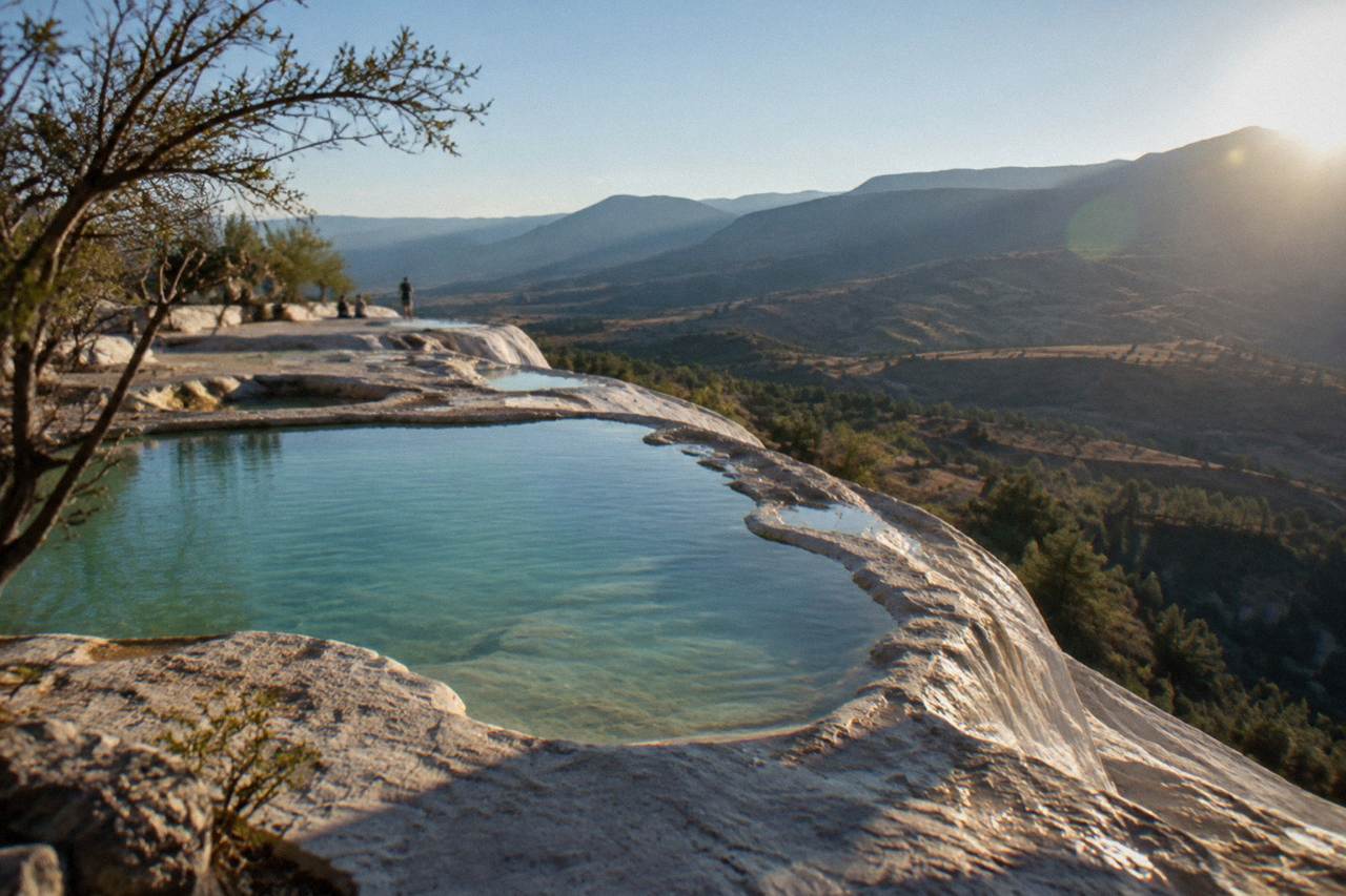 Mineral terraces and still pools at Hierve el Agua above a valley in the Tlacolula Valley