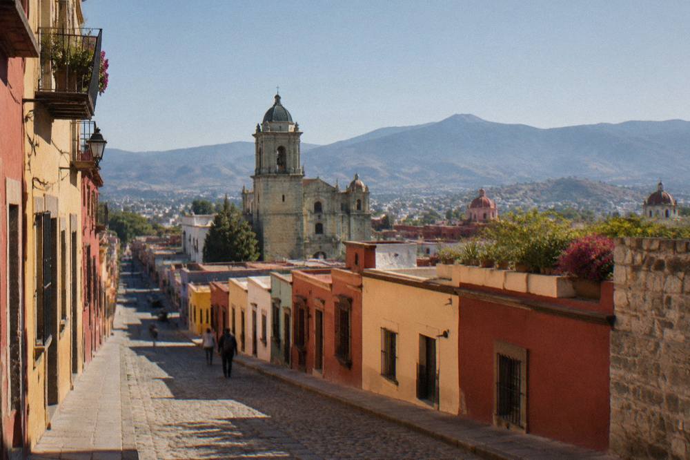 View over the rooftops and churches of Oaxaca City with hills on the horizon