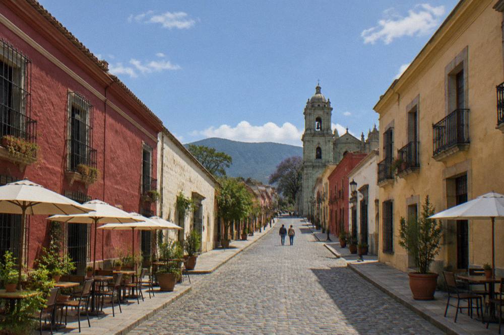 Cobblestone street rising toward a church in an Oaxaca neighbourhood