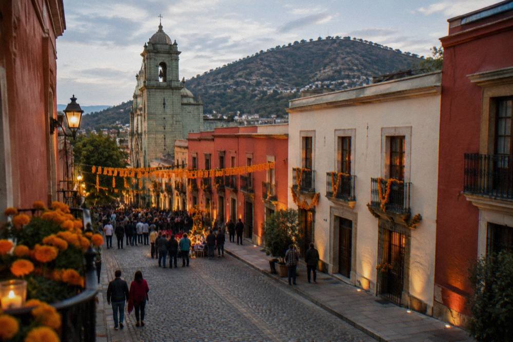 People gathered at an evening street celebration with marigold decorations in Oaxaca City