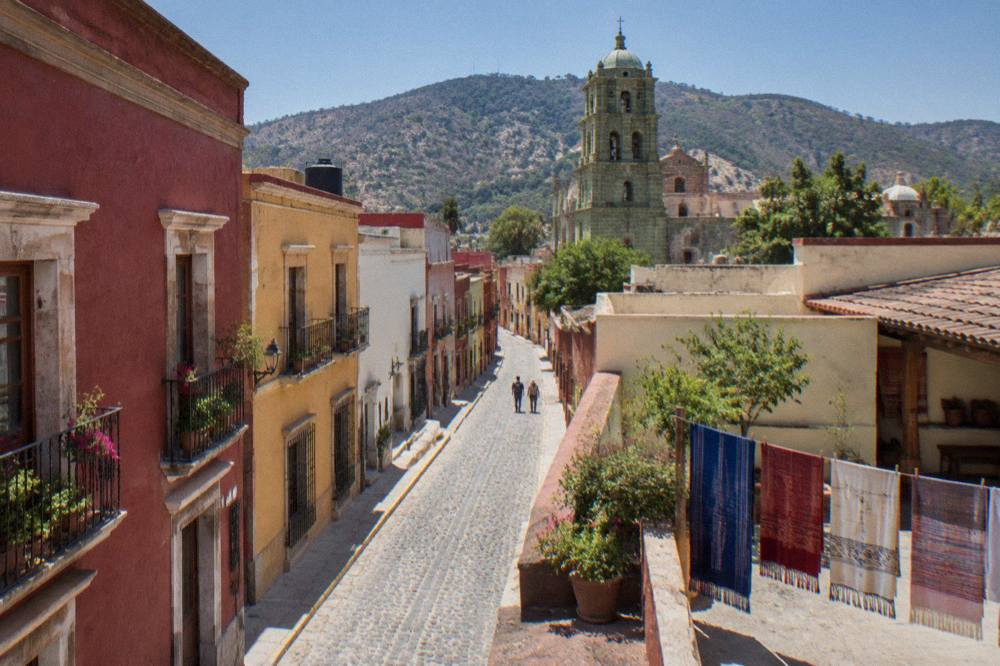 A craft workshop courtyard in a village near Oaxaca City with woven textiles hanging on a line