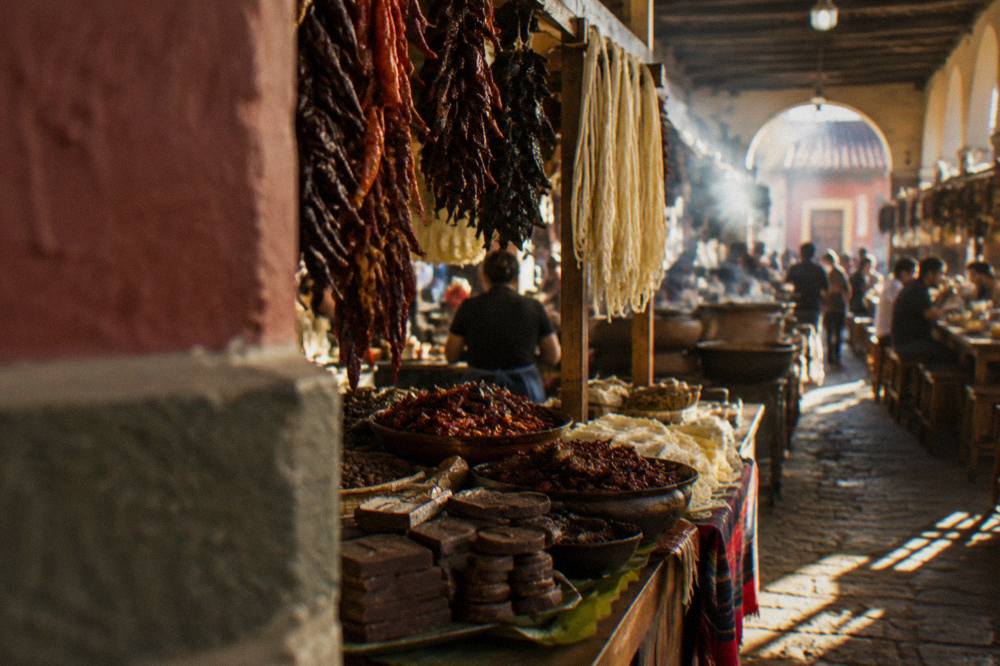 Stall of Oaxacan food goods with chocolate, dried chillies and string cheese on display