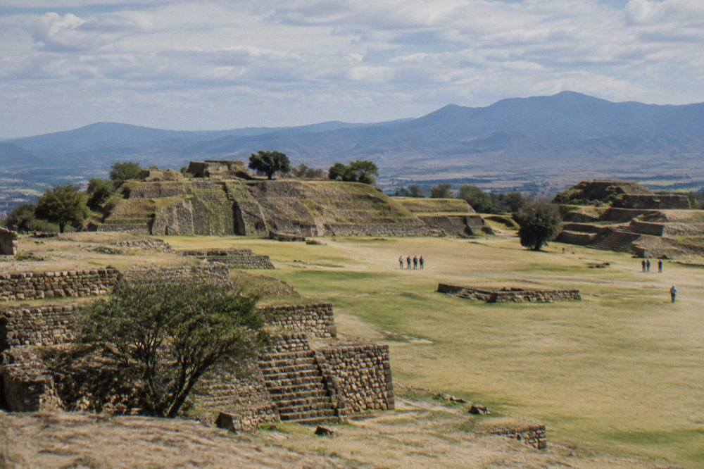 Terraces and stone structures of the Monte Albán archaeological site under a wide sky