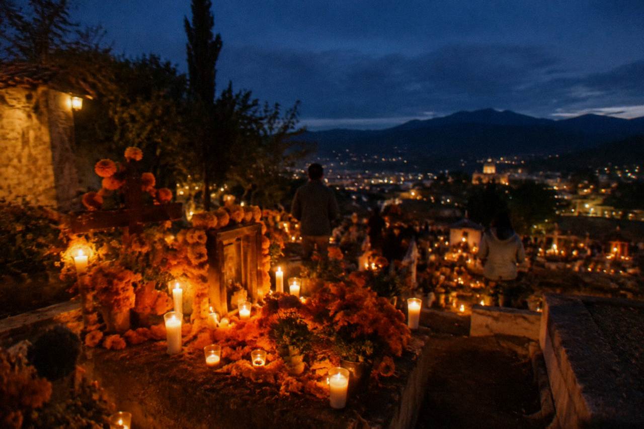 Candlelit cemetery altar decorated with marigolds for Day of the Dead in Oaxaca