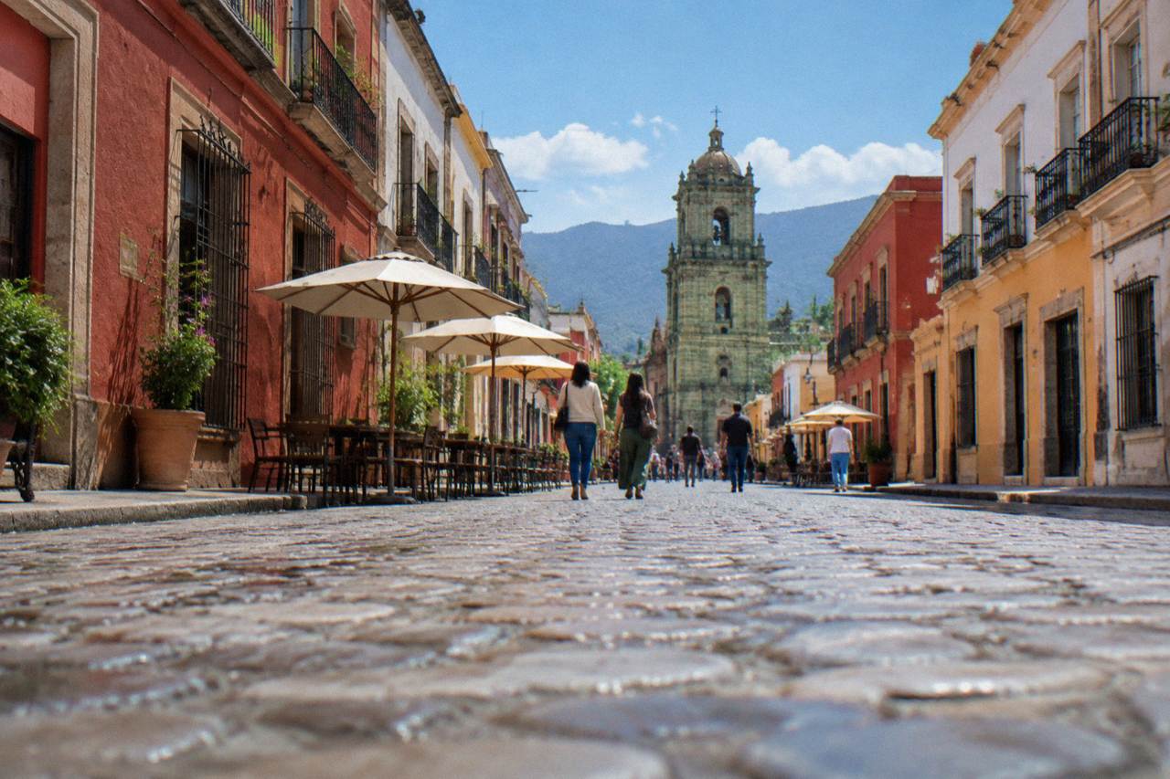 A pedestrian street in Oaxaca City's historic centre with colonial buildings and people walking
