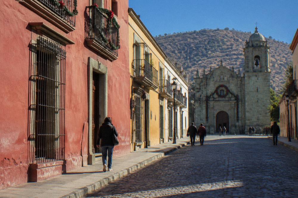 A church facade and street in Oaxaca City decorated for December festivities