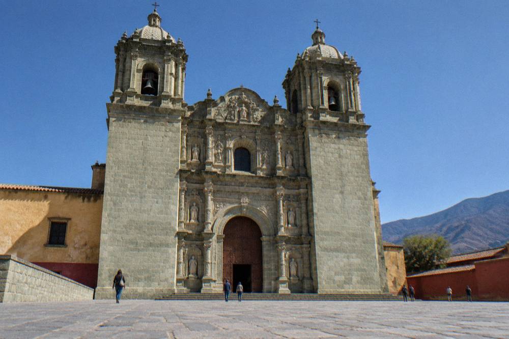 The facade of the Santo Domingo de Guzmán church in Oaxaca City with the pedestrian street in front