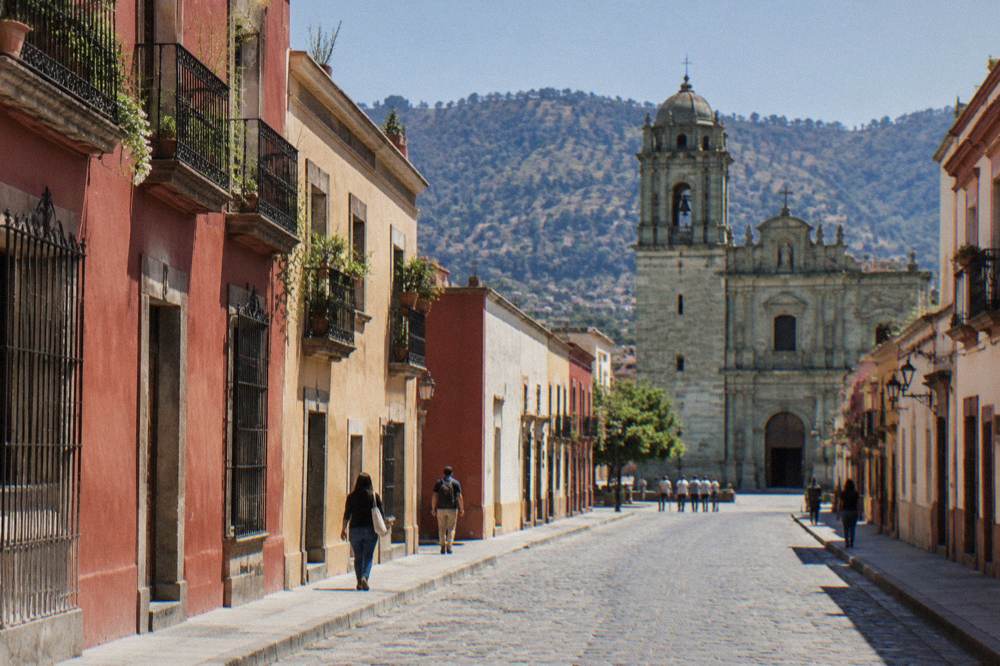 A stone church facade rising above a plaza in Oaxaca City's historic centre