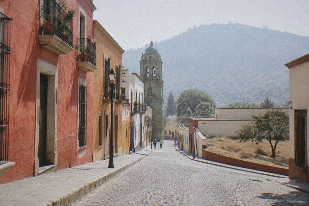 A low building and open ground on the southern edge of Oaxaca City near the airport road
