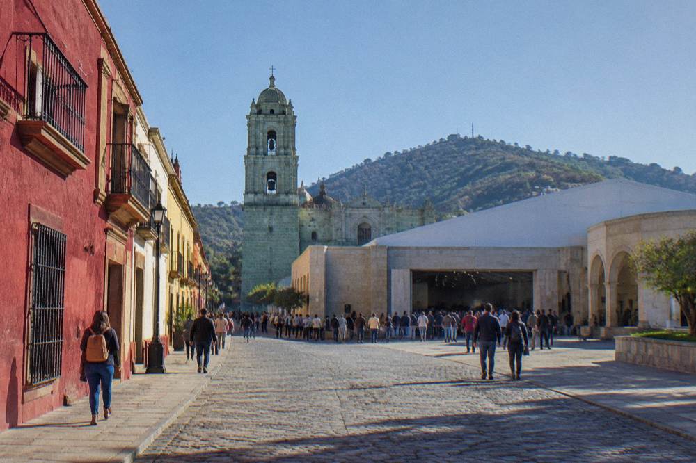 Fairground halls of a convention centre in Oaxaca with a crowd at an entrance
