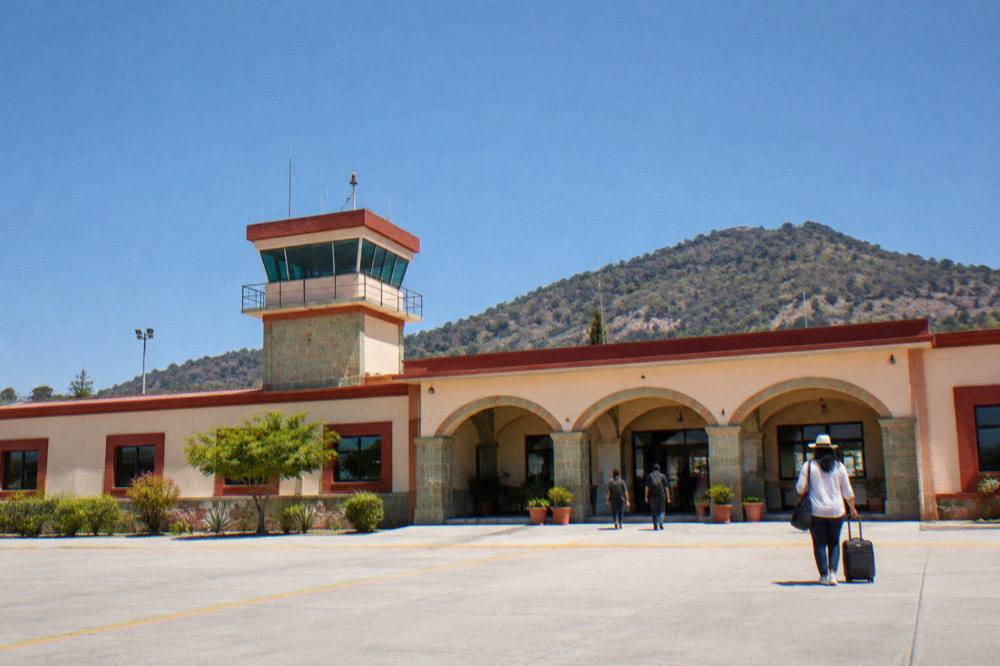 Small airport terminal building in Oaxaca under a clear sky