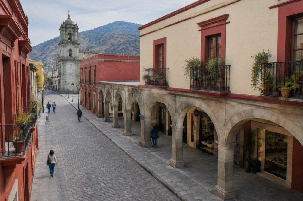 A colonial arcade and gallery storefront along a pedestrian walkway in Oaxaca