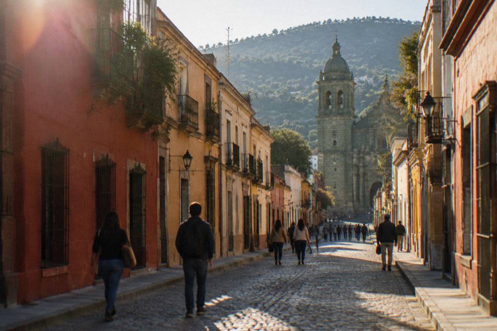 People walking along a central street of Oaxaca City towards the Basílica de la Soledad