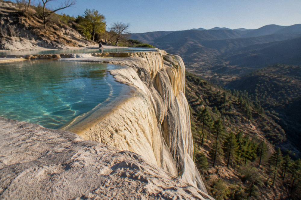 Golden afternoon light on the white mineral cascades at Hierve el Agua