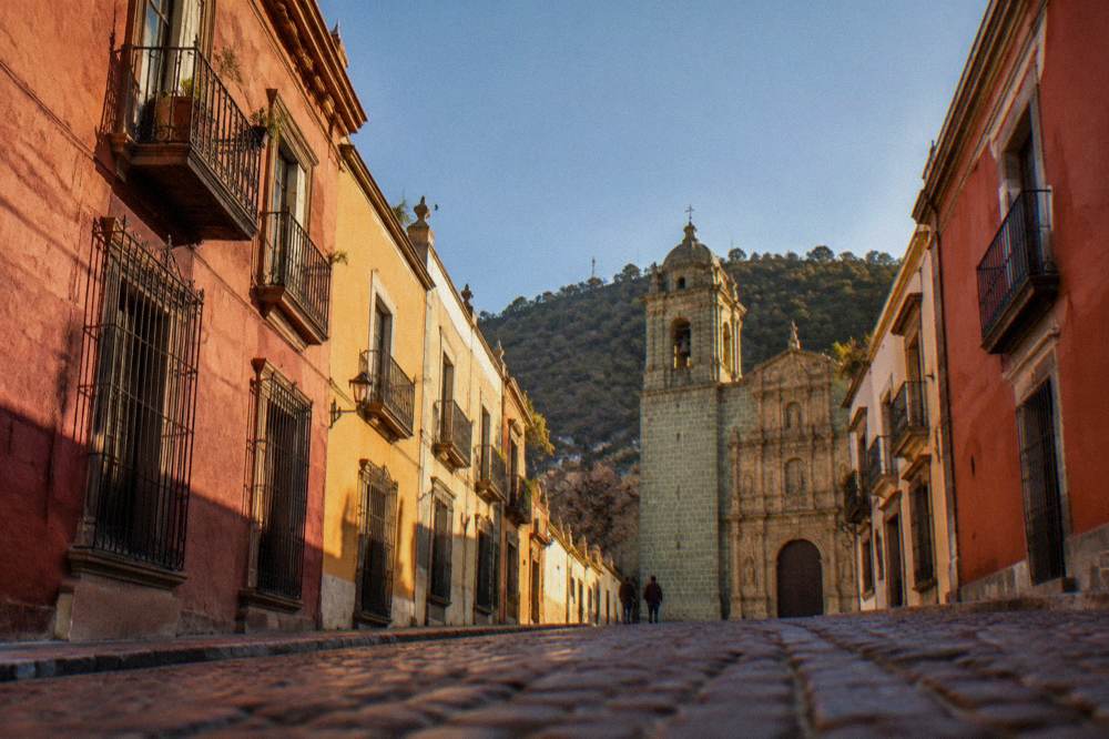 A stone church facade with carved detail in Oaxaca City under a clear sky
