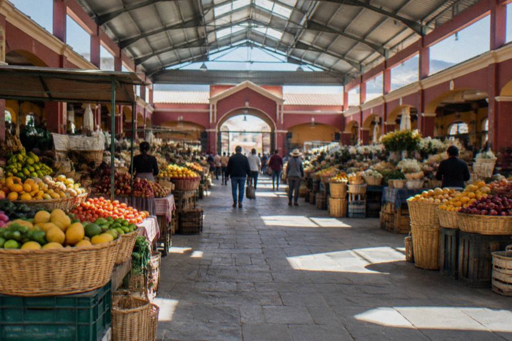 Wide view of a covered market hall with shoppers between stall aisles