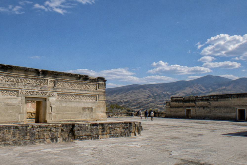 Late afternoon light on ancient stone courtyards with mountains in the distance