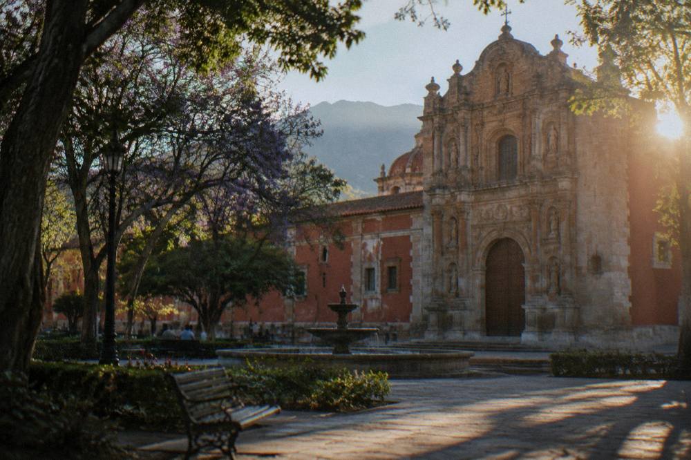An ornate stone facade of a former convent building in evening light