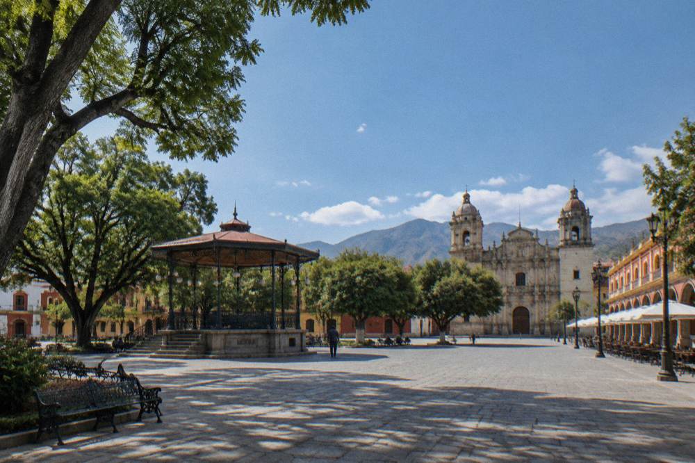 The Zócalo main square of Oaxaca City with its kiosco and shade trees
