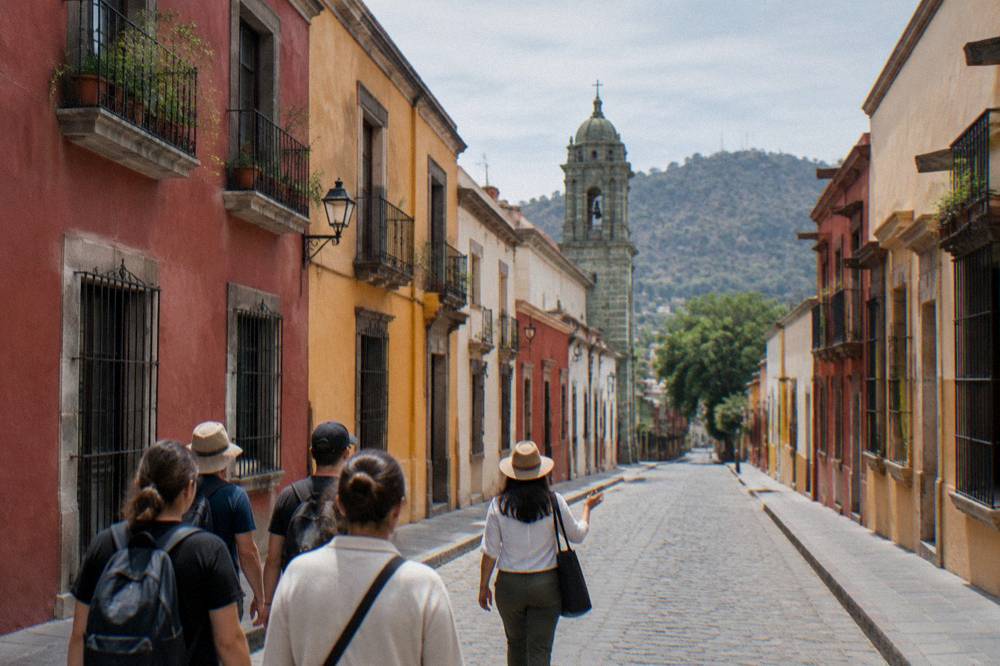 A local guide leading a small group on a walking tour through the streets of central Oaxaca City