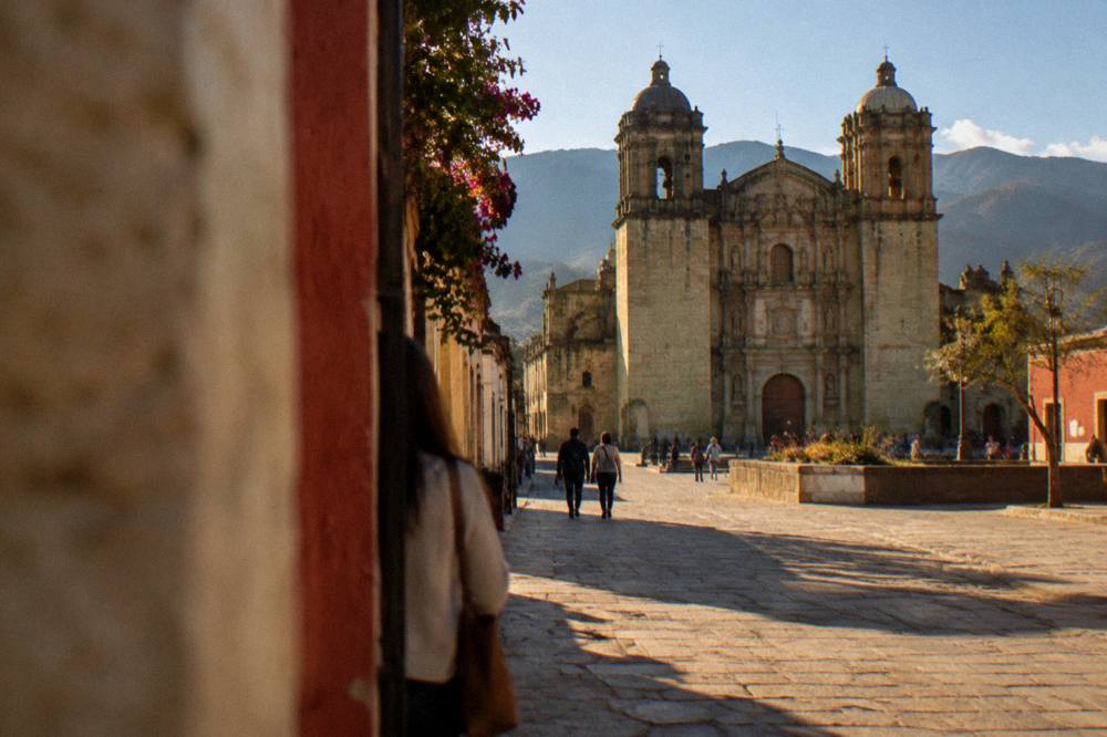 People walking on a pedestrian street in the historic centre of Oaxaca City near Santo Domingo
