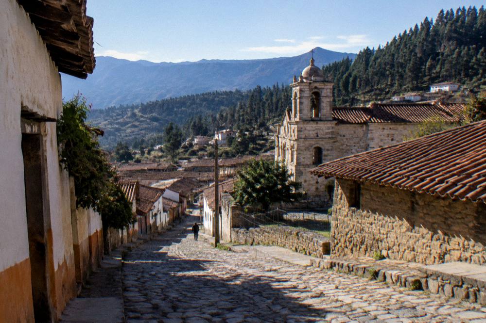 Rooftops of Oaxaca City's historic centre with mountains on the horizon