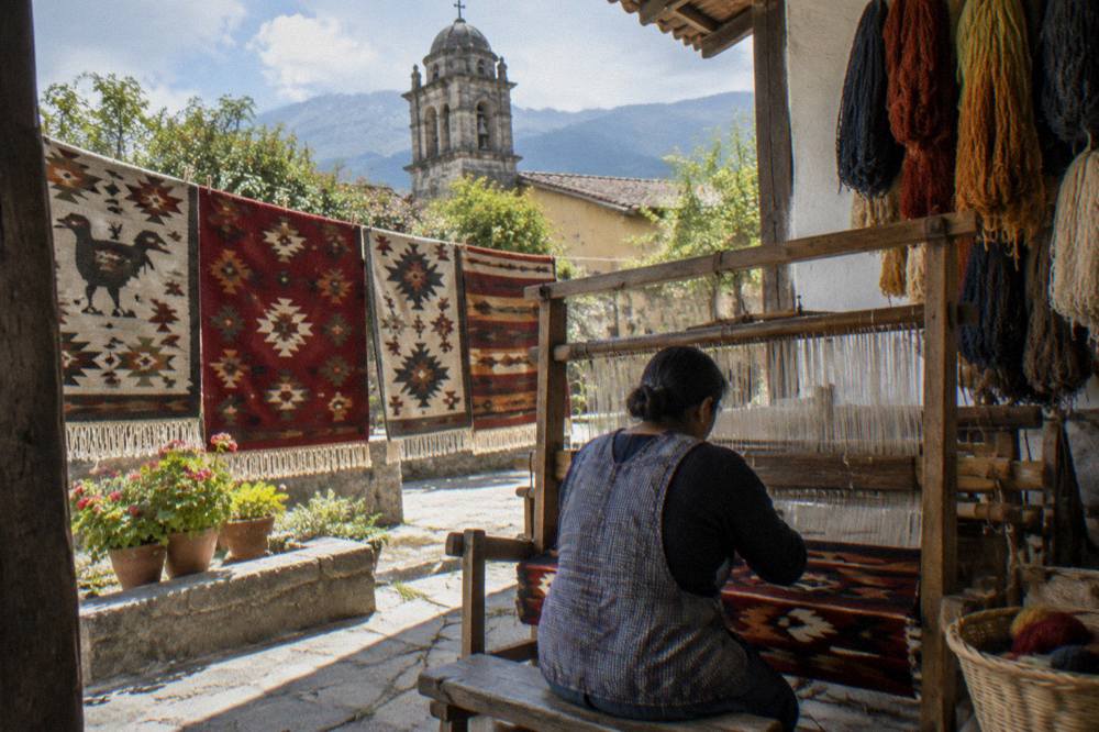 Weaver working a loom in a workshop in Teotitlán del Valle