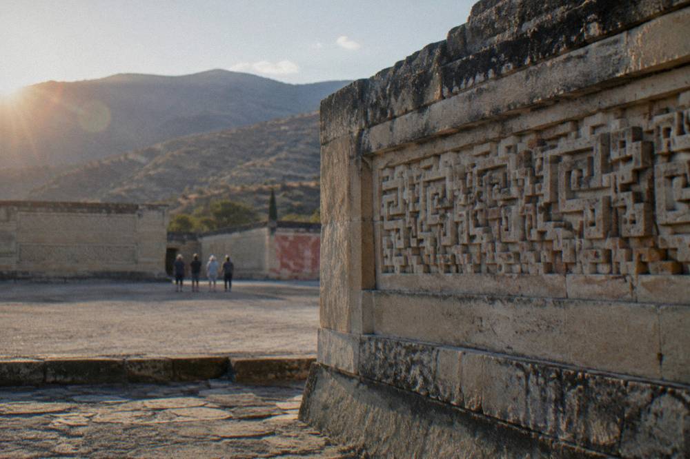 Geometric fretwork carved into a stone wall at Mitla