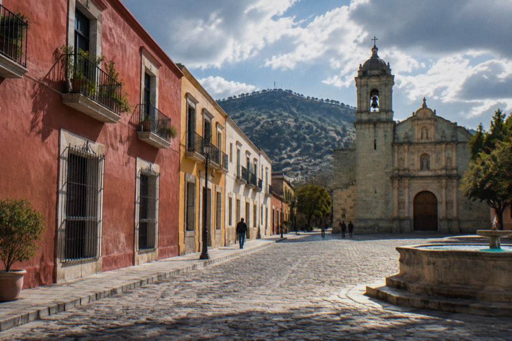 A stone plaza with a historic church facade in the Oaxaca historic centre