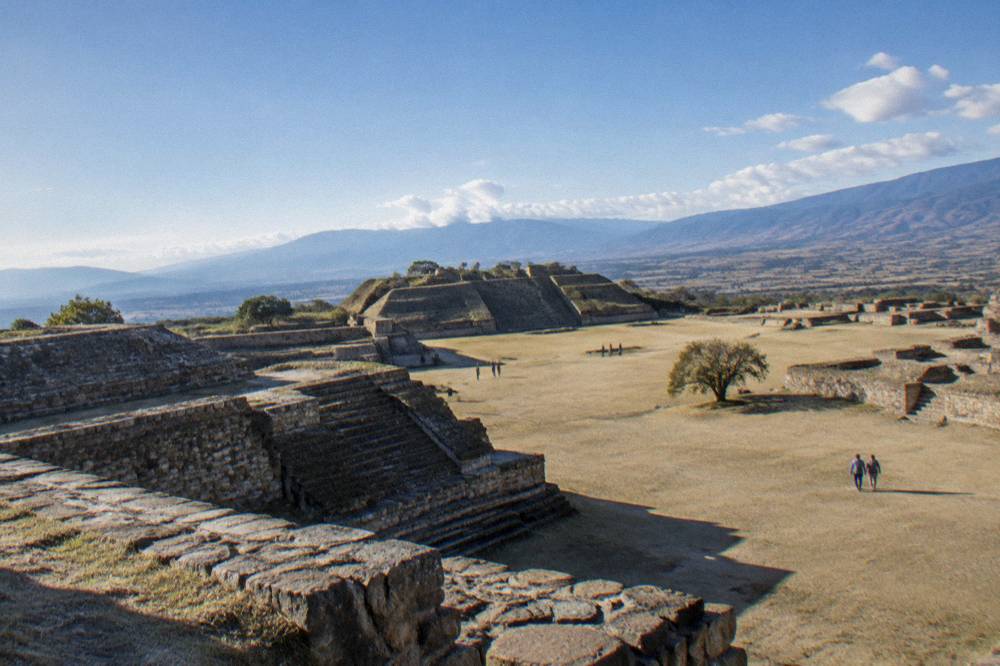 Ancient stone terraces of Monte Albán under a wide sky above the valley