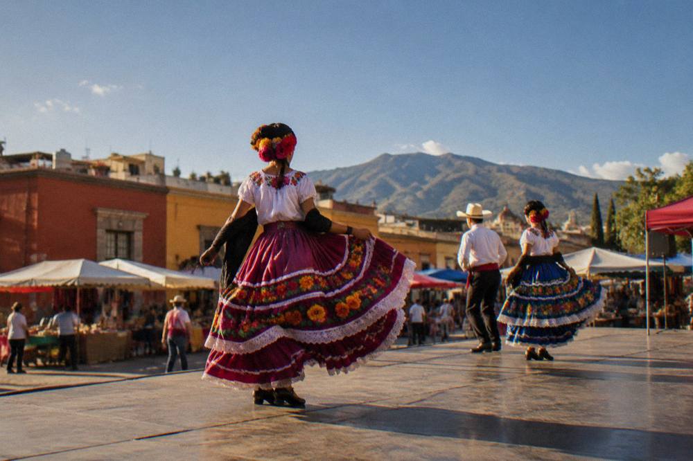 Dancers in regional dress performing on an outdoor stage during a festival