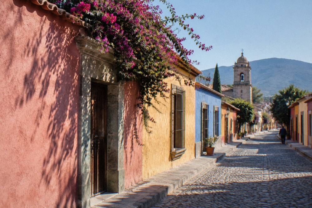 A quiet colonial street in Jalatlaco with painted walls in the late morning light