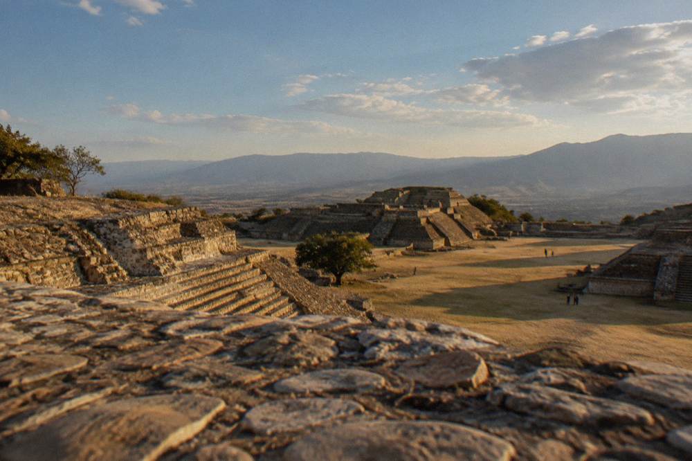 The stone terraces of the Monte Albán archaeological site under a wide sky