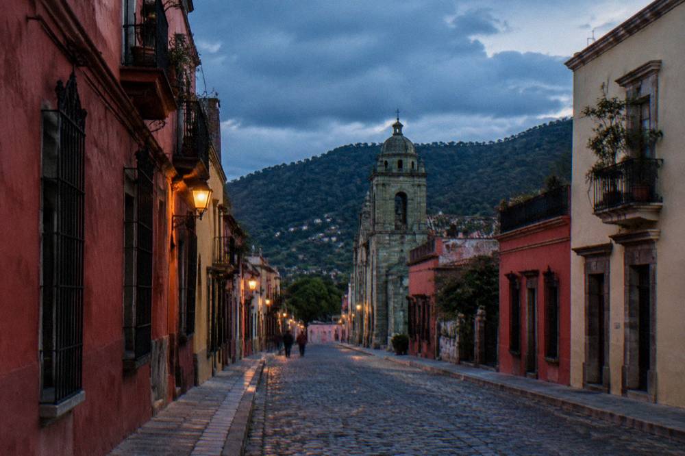 Rain clouds gathering over green hills on a road in the Oaxaca valleys