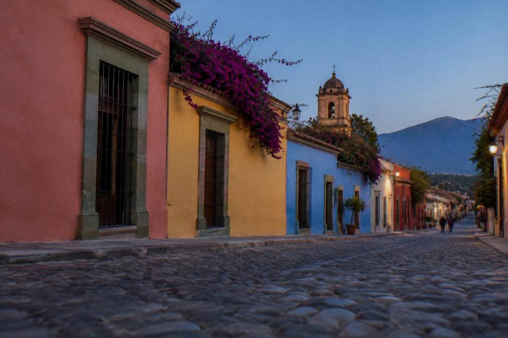 A colonial street in the late afternoon with warm light on painted facades