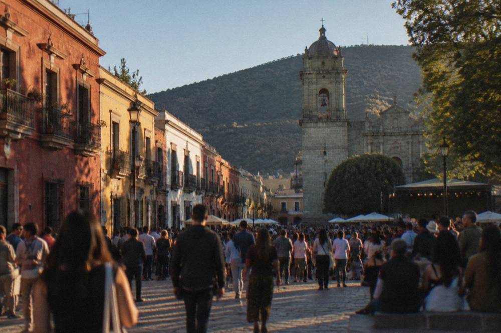 An evening crowd filling a plaza in Oaxaca during a festival period