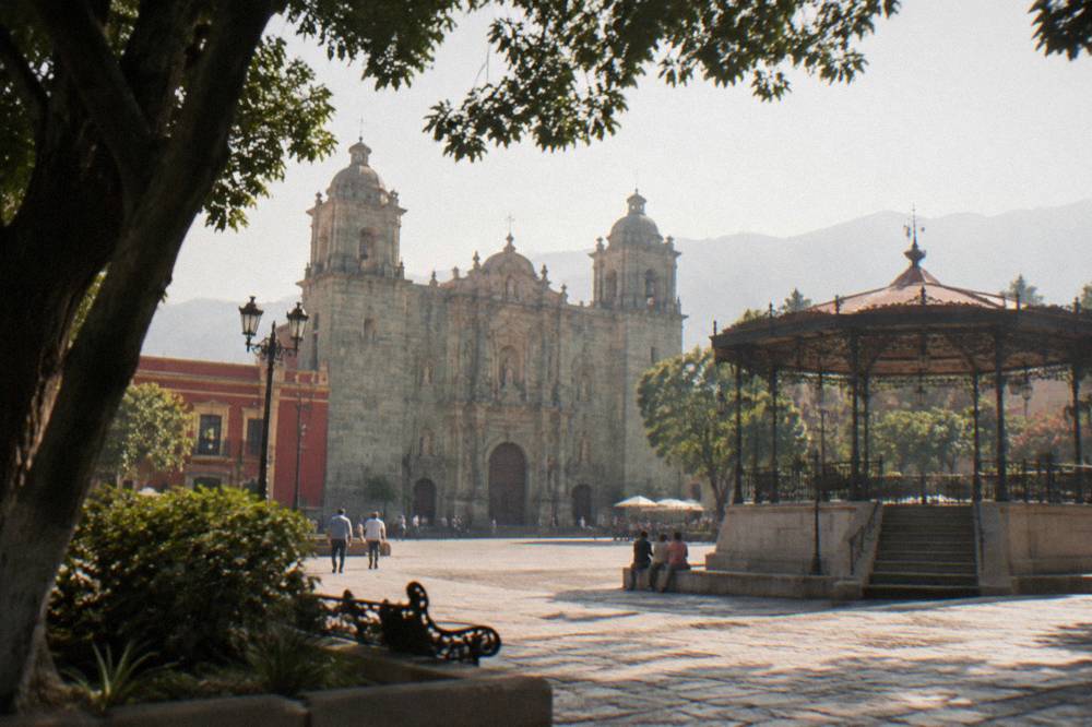 The Zócalo of Oaxaca City with the kiosco and cathedral in the evening