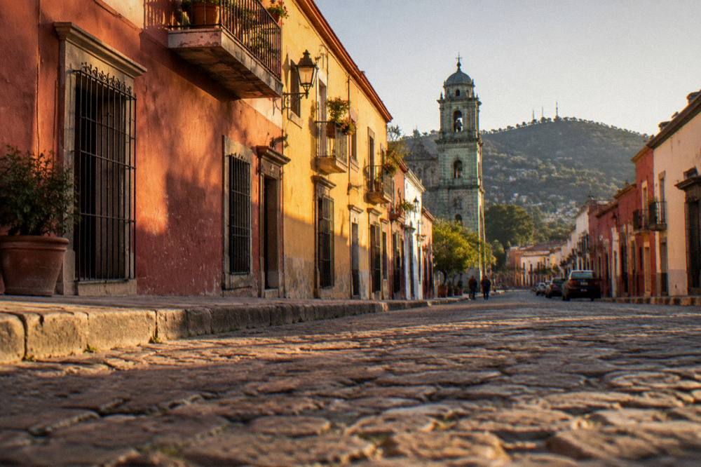 A clear evening sky over the rooftops and church towers of Oaxaca City