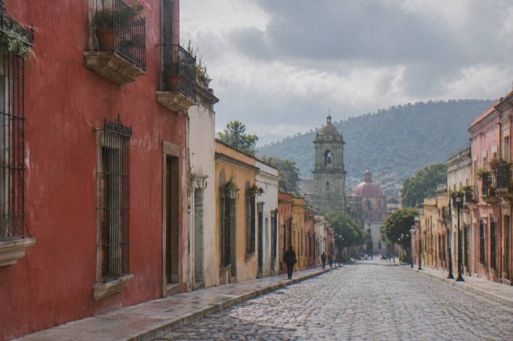 Afternoon rain clouds over the rooftops and church domes of Oaxaca City