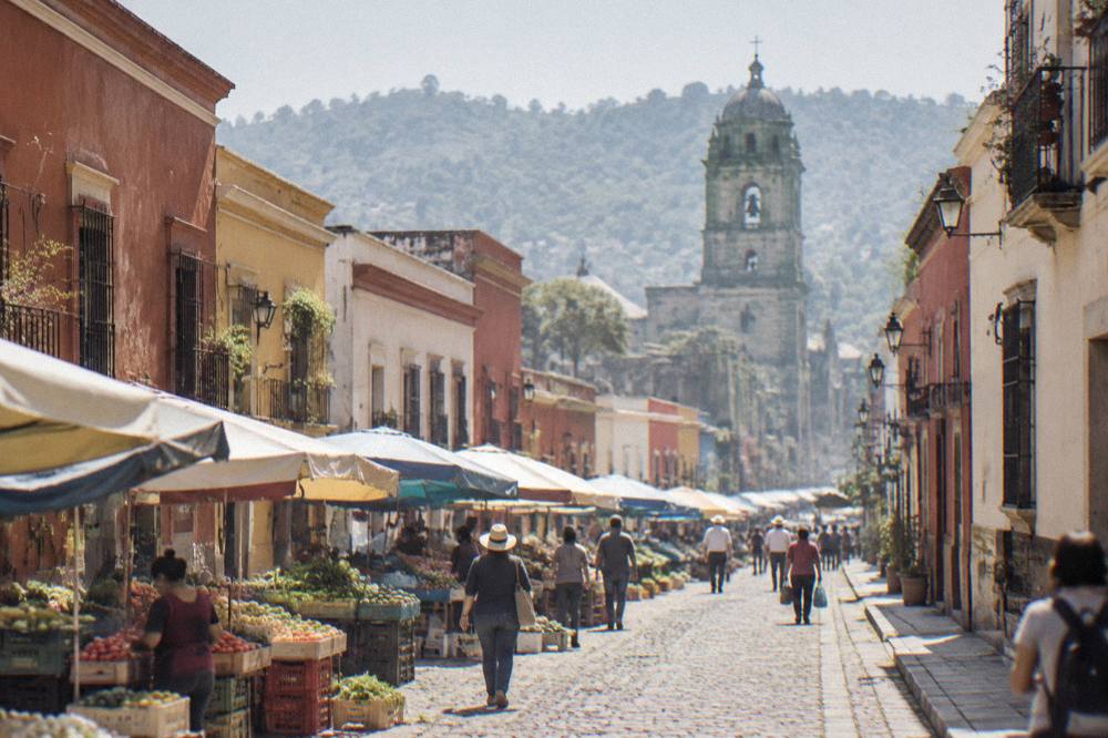 A busy weekly market street in a Oaxaca valley town with produce stalls