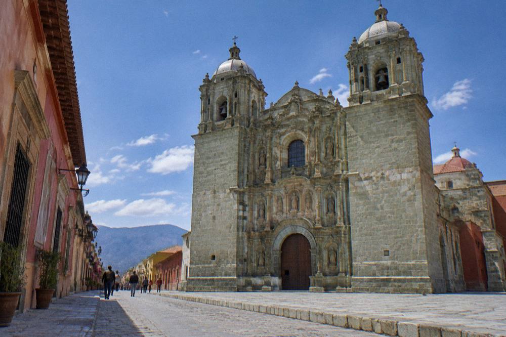 Pedestrians on the Andador Macedonio Alcalá with the Santo Domingo church ahead