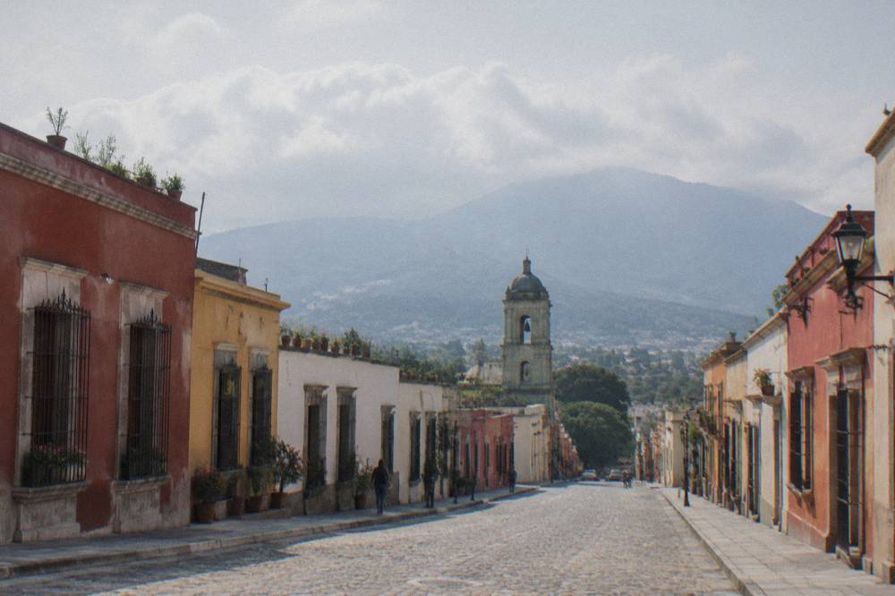 Rain clouds over the mountains surrounding the Oaxaca valley with the city below