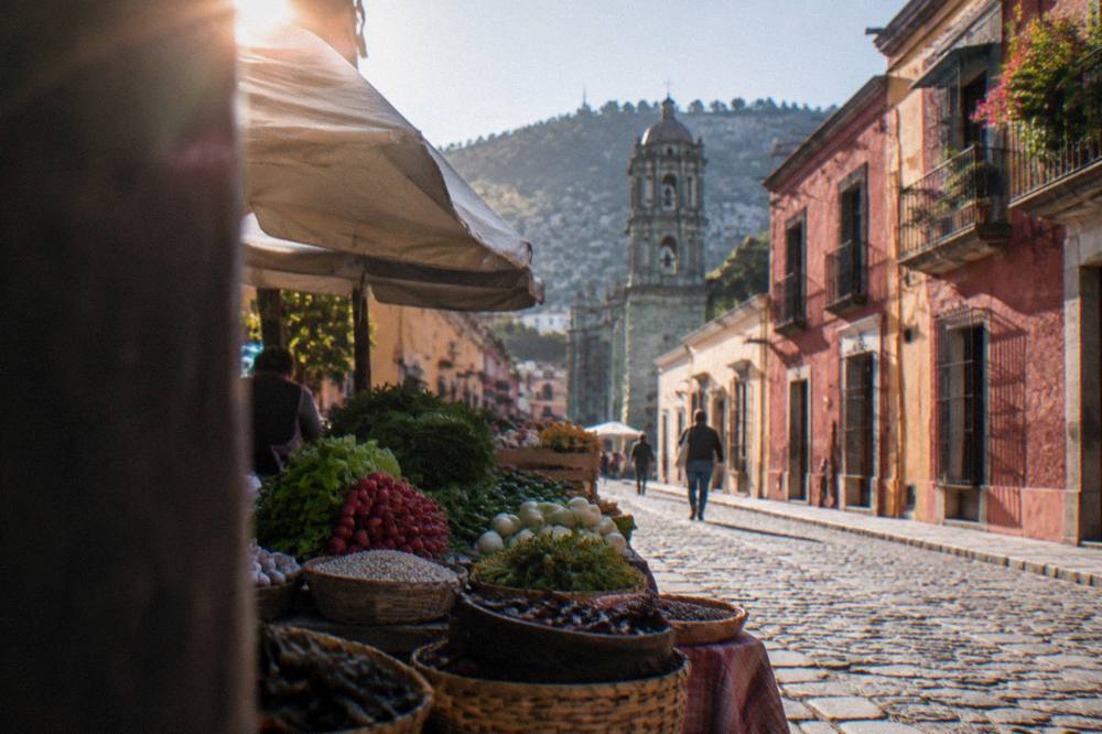 A market stall in Oaxaca City with fresh vegetables and traditional ingredients laid out