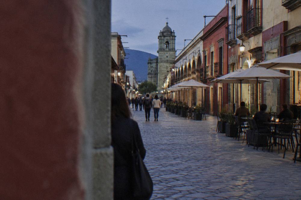 Colonial arcade and café tables along a pedestrian street in the historic centre of Oaxaca City