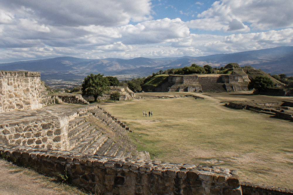 Stone terraces of the Monte Albán archaeological site on a flattened hilltop above the valley