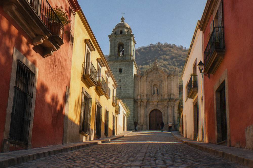Church facade and ornate doorway in the historic centre of Oaxaca City in late afternoon light