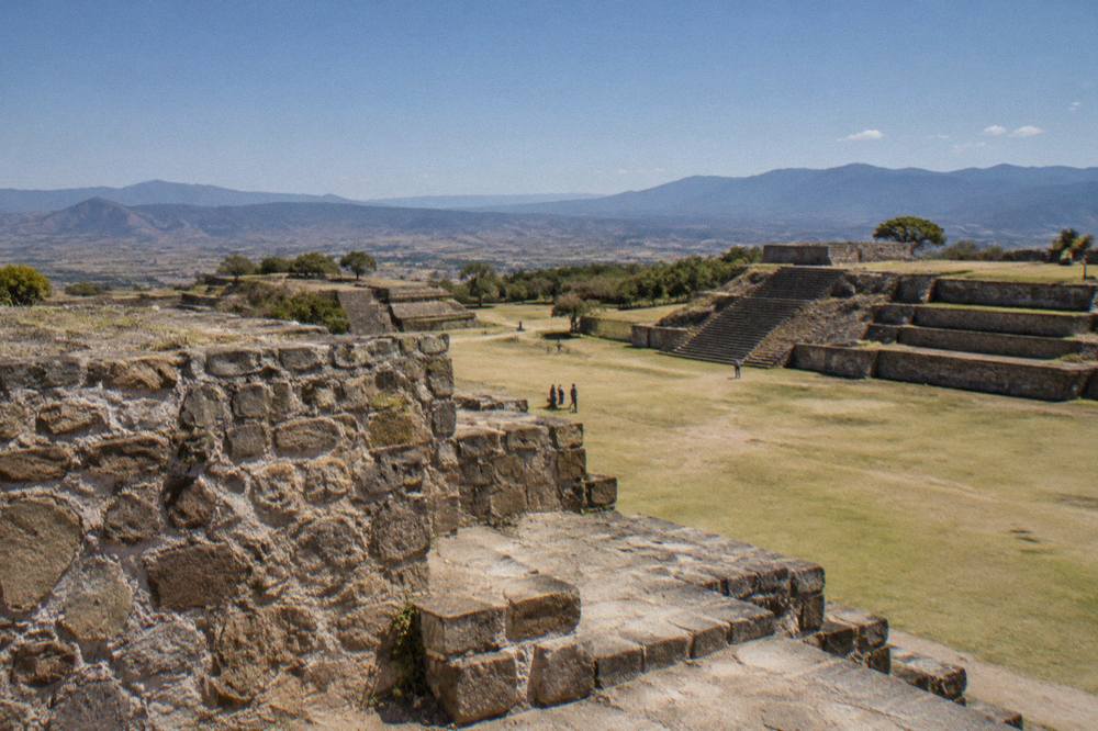 Stone terraces and platforms of the Monte Albán archaeological site under a clear sky