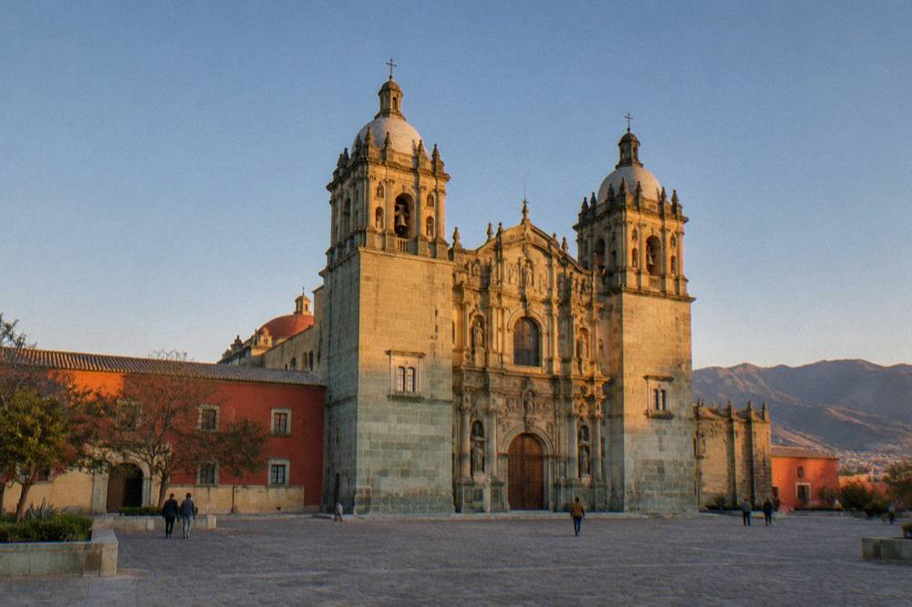 Sunset light on the green quarry stone facade of the church of Santo Domingo de Guzmán in Oaxaca